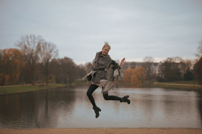 Full length of woman standing in lake