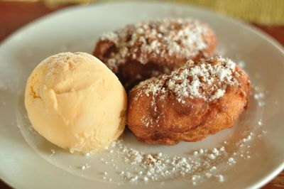 Deep fried bananas served with ice cream in plate