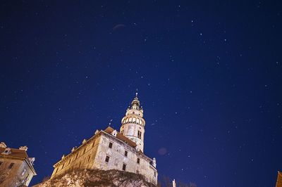 Low angle view of castle against star field in blue sky at night