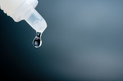 Close-up of liquid dropping from pipette