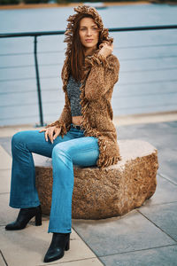 Portrait of young woman sitting outdoors