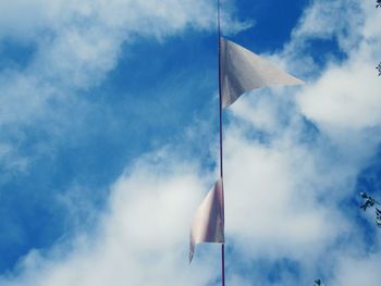 Low angle view of flag against cloudy sky