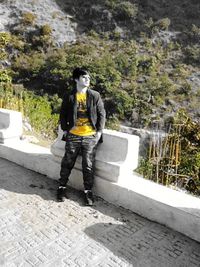 Man standing on tree trunk