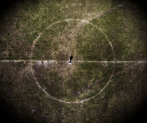 High angle view of silhouette person standing on soccer field