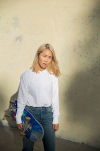 A young woman with a skateboard