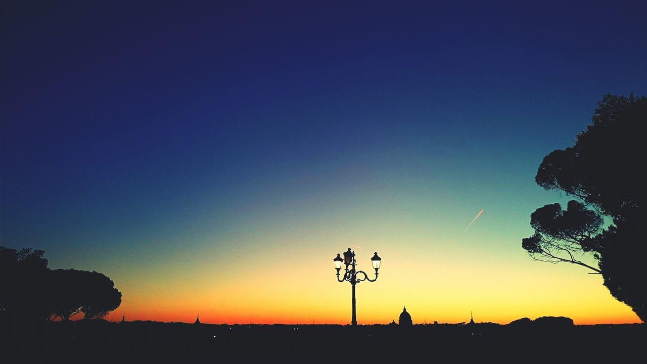 silhouette, sunset, copy space, clear sky, tranquil scene, beauty in nature, tranquility, scenics, tree, landscape, nature, blue, orange color, idyllic, sky, field, dusk, outline, outdoors, growth