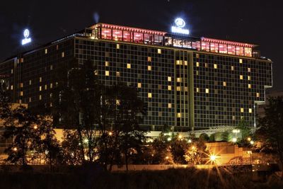 Illuminated building against sky at night