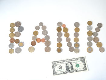 High angle view of coins on white background