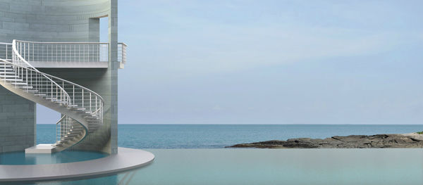 View of swimming pool by sea against sky