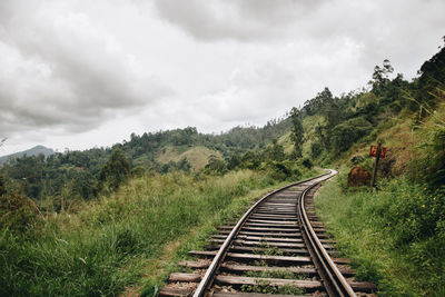 View of railroad tracks against cloudy sky