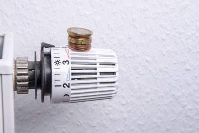 High angle view of telephone on table against white wall