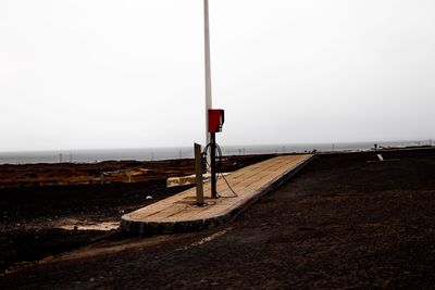 Street light by road against clear sky