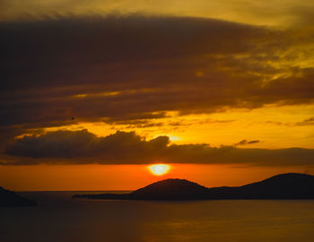 Scenic view of sea against romantic sky at sunset