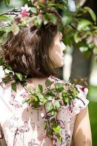 Midsection of woman with flowers on table