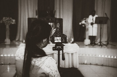 Rear view of woman photographing