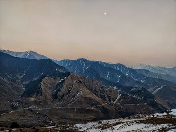 Scenic view of snowcapped mountains against sky during sunset