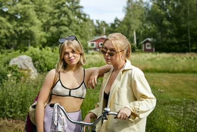 Two friends standing with bicycle