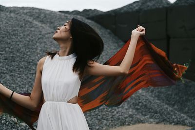 Front view of woman dancing with shawl