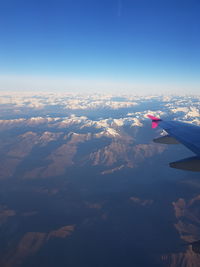 Aerial view of mountain against blue sky