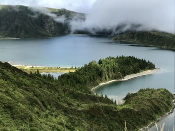 Scenic view of lake and mountains against sky