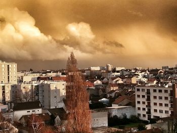 Buildings against cloudy sky