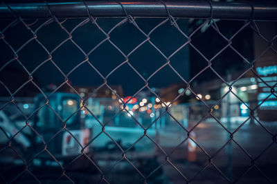 Full frame shot of chainlink fence at night