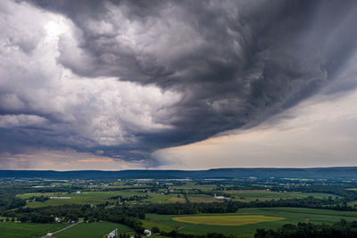 Scenic view of field against cloudy sky