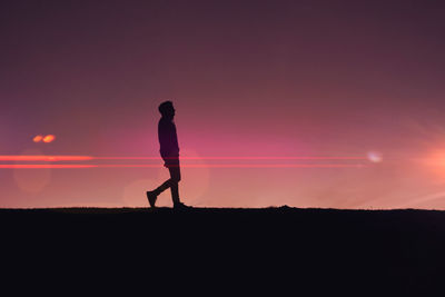 Man silhouette trekking in the mountain with a beautiful sunset