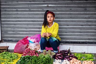 Portrait of woman sitting at market