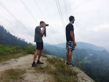 Rear view of man standing on mountain