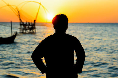 Silhouette of a man on a beach sunset.