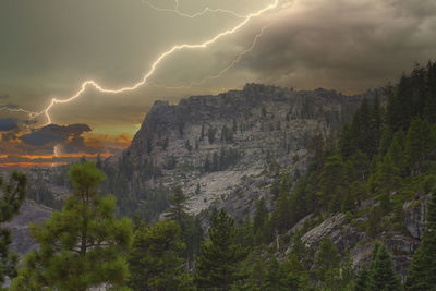 Scenic view of lightning and mountains against sky