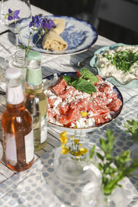 High angle view of fresh cheese and meat in bowl on dining table