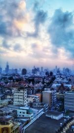 Cityscape against cloudy sky