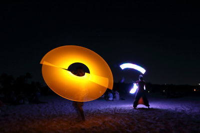 Man and woman standing at night