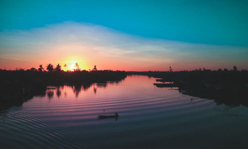 Scenic view of lake against sky during sunset