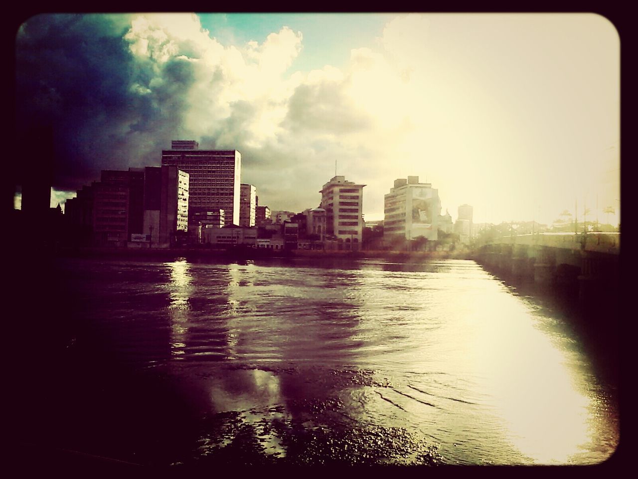 transfer print, water, building exterior, architecture, sky, built structure, auto post production filter, reflection, cloud - sky, waterfront, city, cloudy, cloud, river, dusk, building, weather, sunset, outdoors, overcast