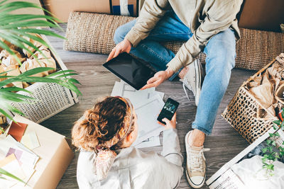 High angle view of woman sitting on sofa at home