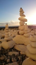 Rocks on shore at sunset