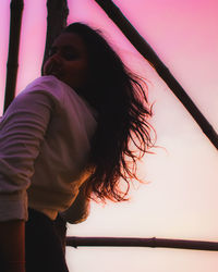 Portrait of woman standing against sky during sunset