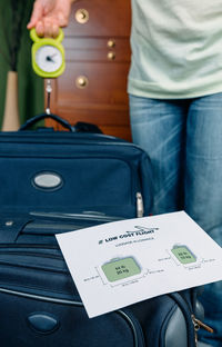 Midsection of man holding while sitting on seat