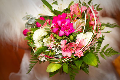 Midsection of bride with bouquet