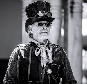 Mature man wearing top hat and sunglasses on sunny day