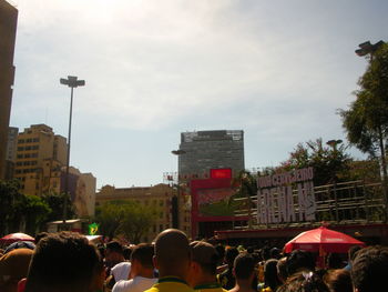 People on street against buildings in city