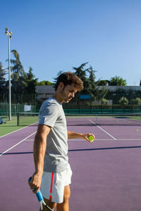 Man playing tennis on court