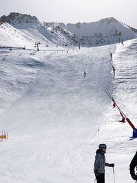 People skiing on snow covered mountain