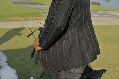 Rear view of woman standing on field