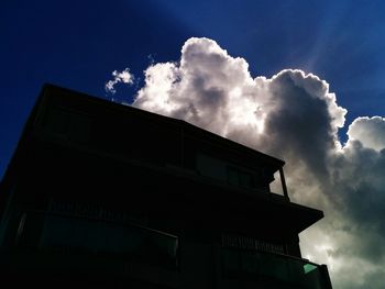 Low angle view of building against cloudy sky