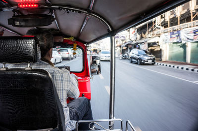 Rear view of man sitting in car