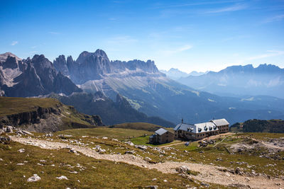 Scenic view of houses and mountains against sky